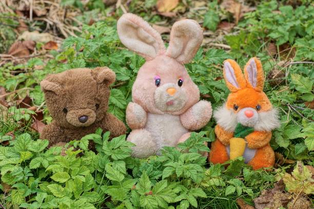 istock three colored plush toys stand in green leaves 1350277008
