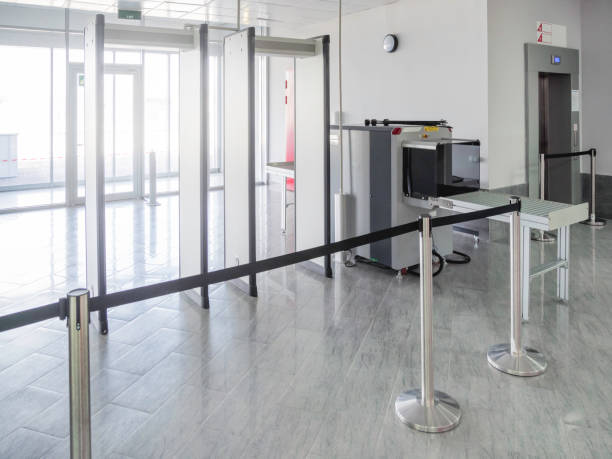 Metal detector frame and X-ray machine for checking luggage and hand baggage at entrance to public building. Checkpoint with security and anti-terrorist measures. Metal detector frame and X-ray machine for checking luggage and hand baggage at entrance to public building. Checkpoint with security and anti-terrorist measures. metal detector security stock pictures, royalty-free photos & images