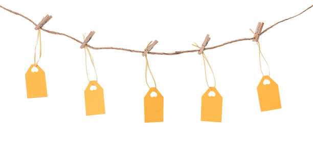 istock Yellow label tags on clothespins on the rope isolated on white. 1350281692