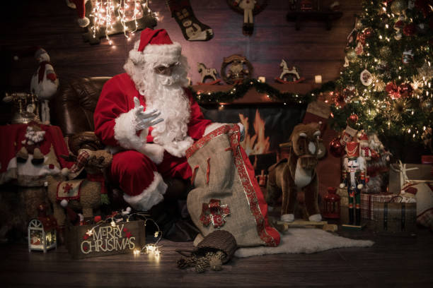 istock Santa is preparing presents in his warm home 1350281871