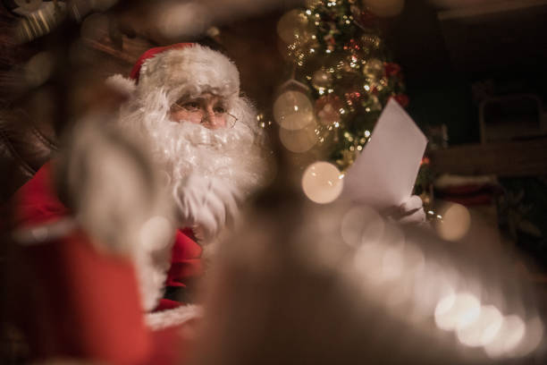 istock Santa is preparing presents in his warm home 1350289611