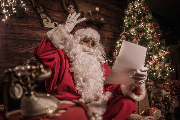 istock Santa is preparing presents in his warm home 1350289616