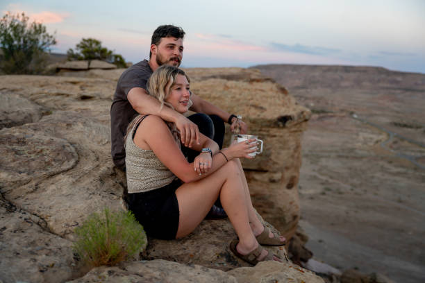 istock Young Couple Enjoying A Romantic Sunrise During A Camping Getaway Weekend 1350289792