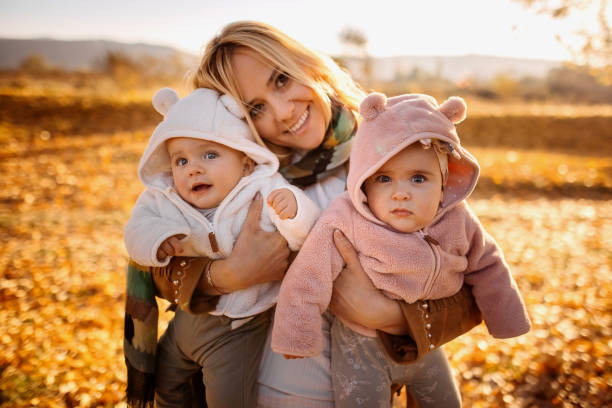 istock Happy mother and twin babies 1350292311
