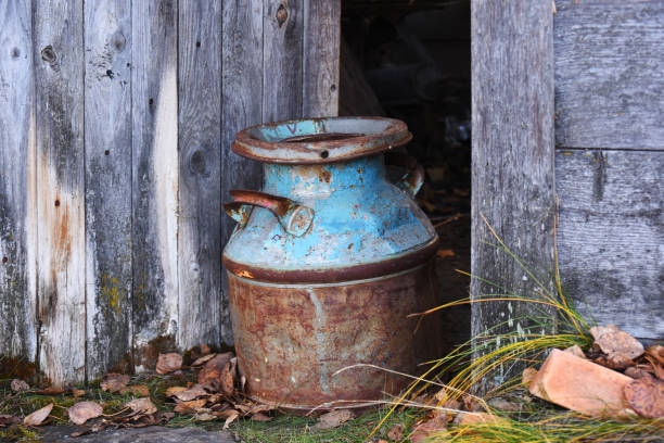 vintage milk cans hanging on the wall of wooden mountain hut