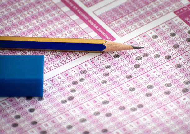 exam answer sheet and pencil with eraser on it