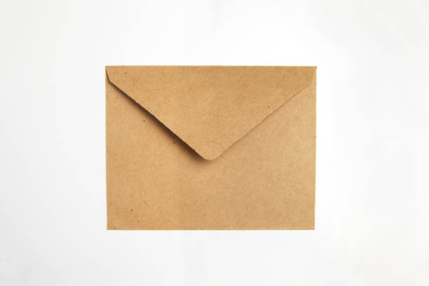 istock Brown craft envelope isolated on white background. Craft eco envelope on white background. Christmas holiday concept. Letter to Santa Claus 1350311499
