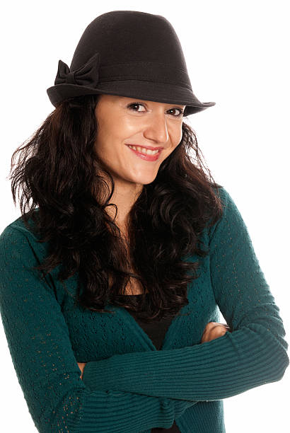 Young beautiful woman with hat arms crossed isolated stock photo