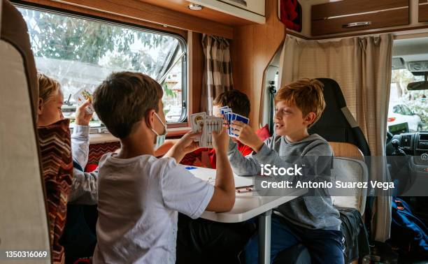 Children Playing Cards In A Caravan Stock Photo - Download Image Now - Motor Home, Playing Card, Camping