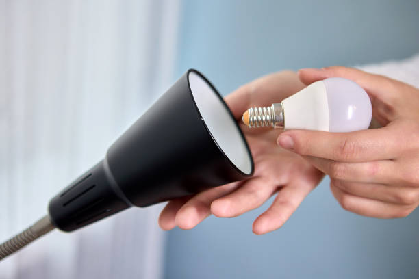 istock Handyman is changing LED light lamps in floor lamp. 1350318905