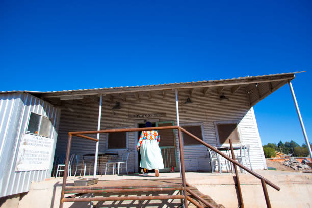Marfa, TX: A women entering the the historic Godbold Feed Building in downtown Marfa, recently turned into a distillery.