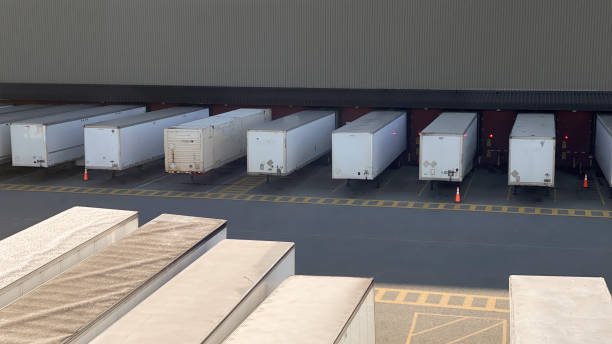 istock Unknown transit transportation hub transit destination travel delivery post carrier airlines car cargo drivers box upload download out parking containers container store storage space garage factory sun shadows tracker truck stop 1350329275