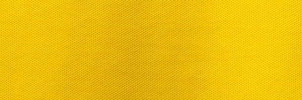 żółty kolor odzieży sportowej tkanina koszulka piłkarska jersey tekstura i tło tekstylne, szeroki baner. - carbon fiber textile pattern zdjęcia i obrazy z banku zdjęć
