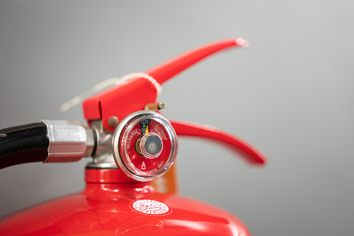 Pressure indicator gauge of fire extinguisher, using for measuring the chemical injection pressure level. Close-up and selective focus at the gauge's part.