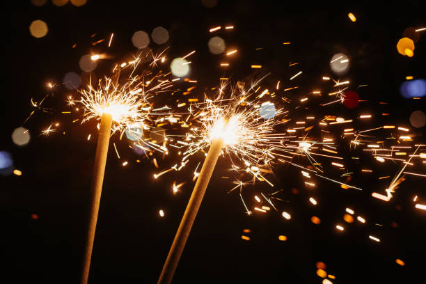 istock Bright glittering sparkler on blurred bokeh background 1350342548