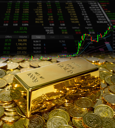 Gold bullion on the coin at trading chart background