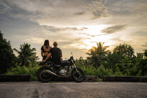 istock Couple watching sunset by the road 1350345237