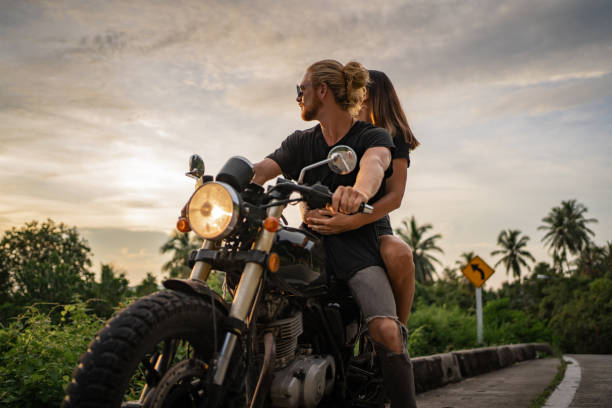 istock Couple watching sunset by the road 1350345241