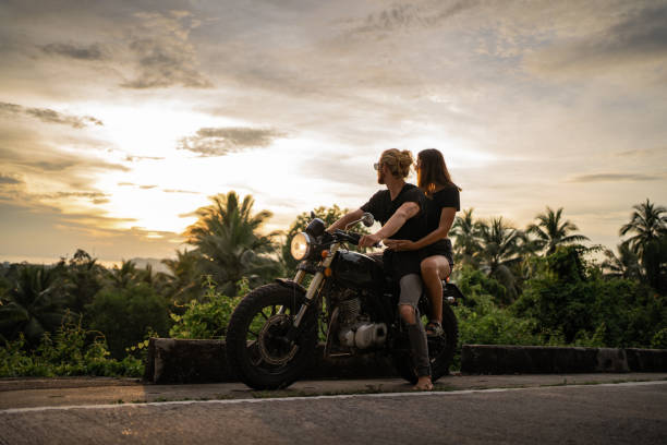 istock Couple watching sunset by the road 1350345243