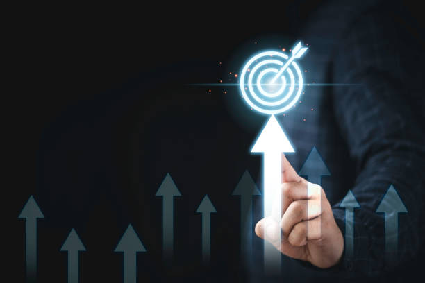istock Hand touching up arrow with virtual target board for enhance and set up business objective target  goal concept. 1350348430