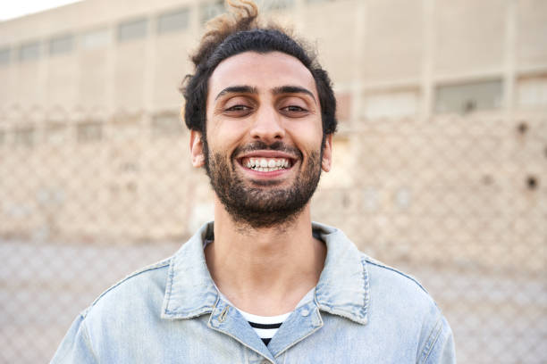 istock Cute brunette man laughing in the street. 1350353090