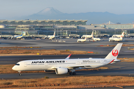 Tokyo, Japan - December 29, 2020:Japan Airlines (JAL) Airbus A350-900 (JA05XJ) passenger plane with Mount Fuji.