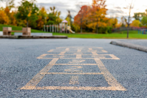 istock School and schoolyard with hopscotch and playground for elementary students in evening in fall. 1350357315