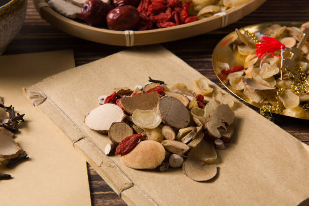 istock traditional Chinese medicine herbal on old book 1350362739