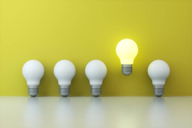 istock Light bulbs on yellow background. Idea and Innovation Concept. 1350364700