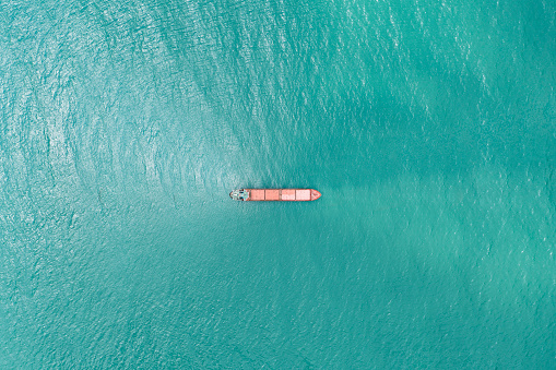 Cargo ships standing on the roadstead. Import, export and business logistic. International sea transportation concept. Aerial view of Black Sea against Samsun city in Turkey.
