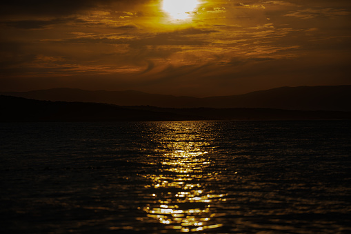 Sunset over the mountains of the Croatian coast. A dark scene on the Mediterranean.