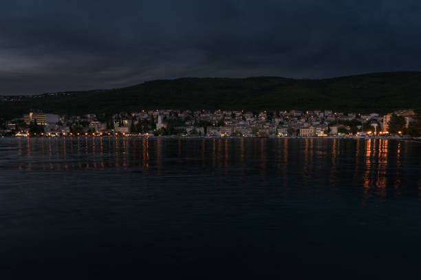 Croatian town Selce in front of the hills illuminated at dusk.