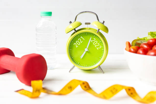 istock 2021 and 2022 on alarm clock with workout planing for dieting. 1350371657