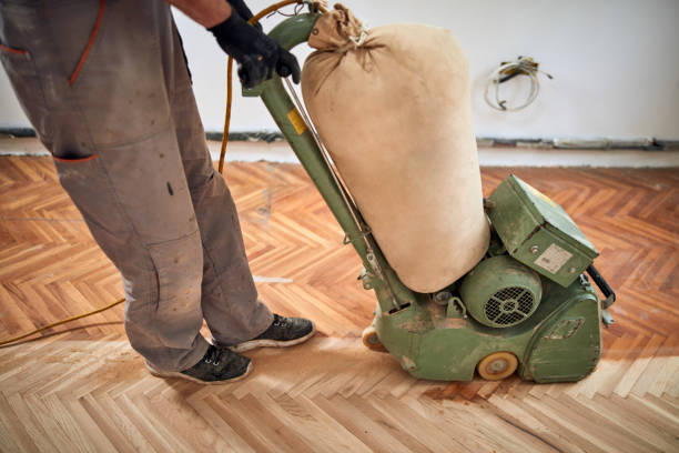 istock Repairman restoring parquet with a sanding machine. 1350372845