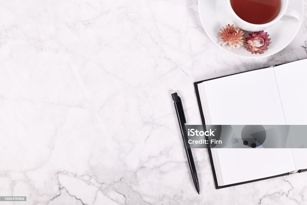 Open empty book Empty open notebook, pencil and tea cup on side of marble table with copy space Tea - Hot Drink Stock Photo