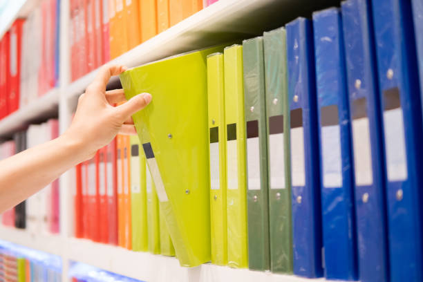 istock Male hand choosing file folder in stationery shop 1350376978