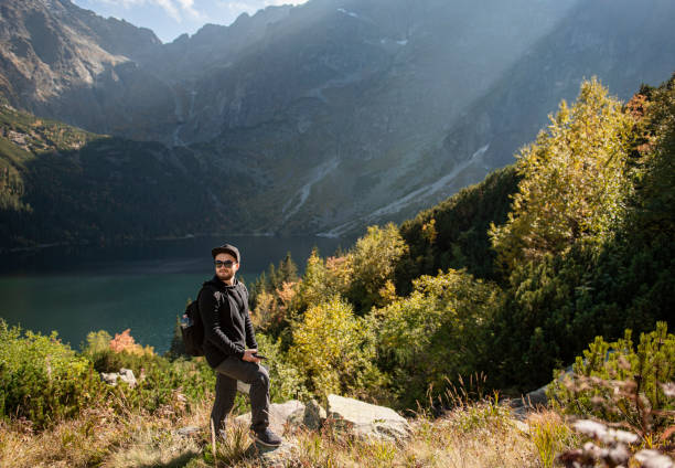 istock Young man traveler with map and backpack 1350379430