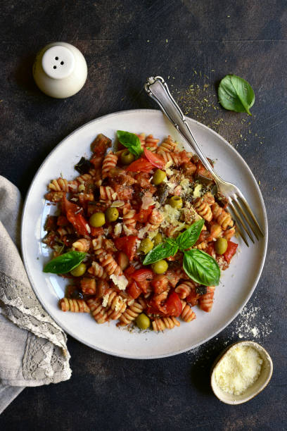 istock Fusilli pasta with tomatoes, eggplants and olives 1350380353