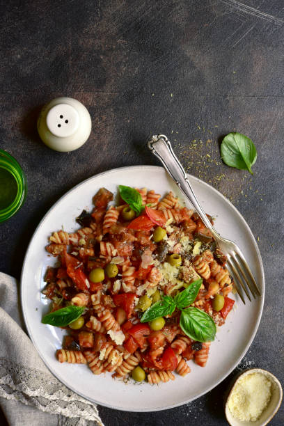 istock Fusilli pasta with tomatoes, eggplants and olives 1350380393