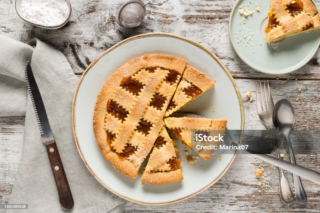 Homemade crostata with apricot marmalad Homemade crostata sweet pie with apricot marmalade served on rustic wooden background Crostata Stock Photo