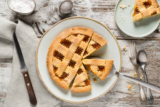 Homemade crostata with apricot marmalad Homemade crostata sweet pie with apricot marmalade served on rustic wooden background crostata stock pictures, royalty-free photos & images
