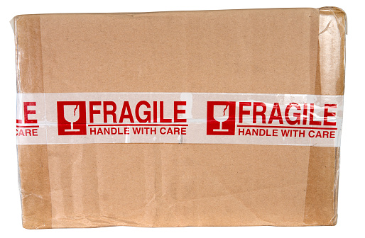 Fragile adhesive tape on top of cardboard box