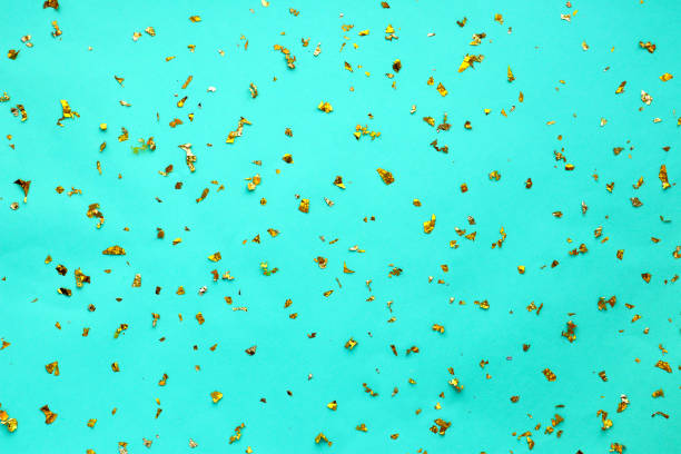 istock Gold sequins sparkle against a light blue (tiffany) festive backdrop. Background for designers, festive background 1350382671