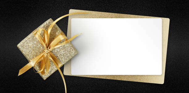 istock Black Friday gift card with golden glittering package and blank white ticket isolated on black background, template for promotional card with copy space 1350383126