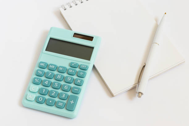 istock Mini calculator, notepad and pen on white background. Top view, flat lay. 1350383890