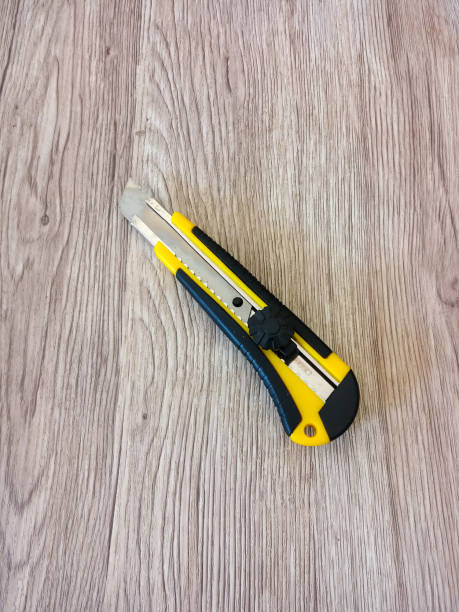 istock cutter knife on a wooden table background 1350383934