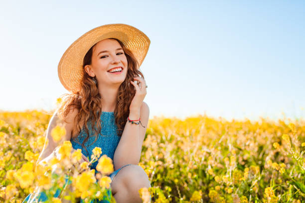Girl in a yellow flower field stock photo