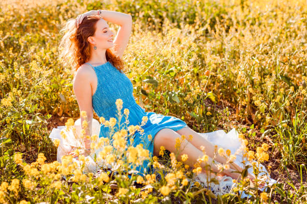 Girl in a yellow flower field stock photo