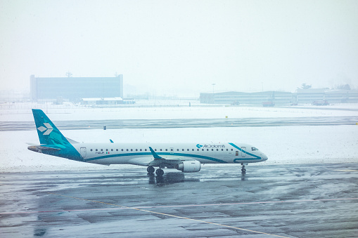 Turin, Italy - January 31, 2019: Airplane on runway in a snowstorm