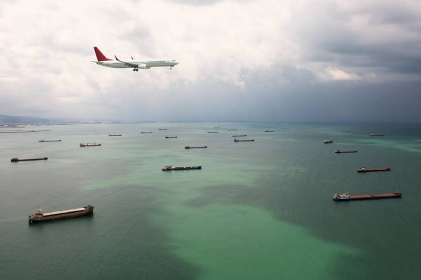 istock Cargo airplane flying above cargo ship. 1350385508